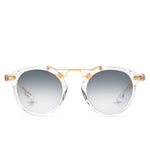 Krewe St. Louis Mirrored Sunglasses feature clear acetate round frames, a gold metal bridge, and a classic silhouette with grey gradient lenses, all displayed against a white background.