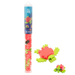 A Plus Plus Tube labeled "Tangerine Turtle" contains colorful interlocking pieces, shown beside two turtle figures assembled from the set—a fun STEM toy that builds fine motor skills.