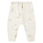 The Quincy Mae Baby Drawstring Pant, crafted from organic brushed jersey, features an elastic waistband and a subtle animal and tree print in soft off-white and neutral tones.