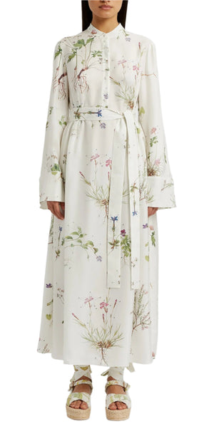 A person wearing the Erdem Long Sleeve Silk Midi Dress With Tie Waist Detail, styled with matching pants and platform sandals.