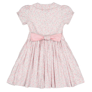 Experience French elegance with Antoinette's Violette Floral Short Puff Smocked Dress, a girls' summer dress featuring a charming floral pattern and a delightful pink bow on the back.