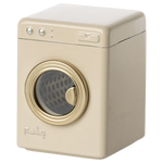 The Maileg Washing Machine, Mouse, is a beige toy with a round clear door, ideal for the mouse family. It features two knobs, a rectangular button on top, and proudly displays the model name on the front.