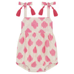 The Mer Baby Girls' Zoe Romper features a pink and white pattern, shoulder tie straps with tassel details, and gathered leg openings.