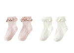 Two pairs of Rylee & Cru Lace Trim Socks—ultra-soft rib knit with delicate lace ruffle, in pink and white—are beautifully displayed on a white background.