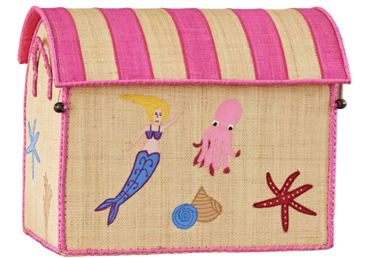 The Rice Raffia Toy Basket is a handmade storage box from Madagascar, decorated with charming mermaids, octopuses, starfish, and shells in beige and pink.
