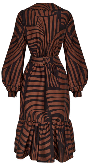 The De Mi Vida Dress by Andres Otalora is a brown and black striped design with long balloon sleeves, a belted waist, and a ruffled hem, shown from the back.
