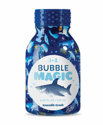 A blue Bubble Magic bottle by Crocodile Creek, decorated with shark and ocean designs—ideal for outdoor bubble play. Suitable for ages 3+ and holds 250 mL; perfect with bubble wands for endless fun.