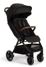 The Nuna TRVL lx Stroller in black features a sun canopy, brown handlebar, four wheels, padded harness seat, and an underseat storage basket—delivering compact luxury for your adventures.