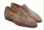 The Magnanni Lecera Loafer is a taupe suede Venetian apron toe shoe featuring stitching details and brown rubber soles, shown on a white background.