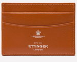 The Ettinger Capra Flat Credit Card Case is a tan leather cardholder with three card slots and an embossed logo on the front, offering minimalist style.