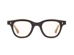 The Caddis Wabi Sabi features thick-rimmed black rectangular eyeglasses with clear, scratch-resistant lenses, displayed front-facing on a white background.