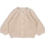 The Louis Louise Baby Girls' Sucrine Knitted Wool Blend Lurex Cardigan features a beige openwork pattern, round neck, long sleeves, ribbed trims, front buttons, and is made from a cozy wool-cotton blend.