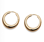 The Andrea Earrings by Lie Studio are classic gold hoops with a smooth, polished finish, displayed on a white background—perfect for elevating your look.