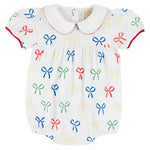 The Beaufort Bonnet Company's Baby Girls' Cindy Lou Bubble features a white design with a Peter Pan collar, red trim, and multicolored bow prints—perfect for adding charm to your little one's wardrobe.