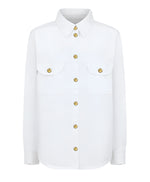 Introducing Blaze Milano's Clapotis Berber Shirt: a white long-sleeve button-up with gold buttons. Ideal for summer, it features a relaxed fit and two chest pockets with buttoned flaps.