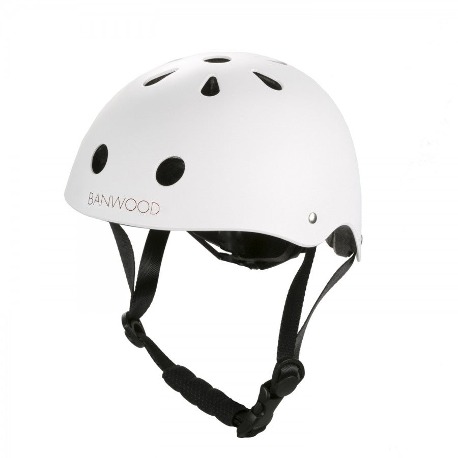The Children's Helmet by Banwood is white with black ventilation holes, an adjustable chin strap, and a durable ABS hard-shell for reliable protection. Its sleek design features a convenient dial fit adjustment and stands out against a plain background.