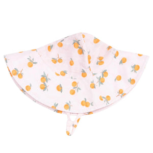 The Angel Dear Wide Brim Sunhat is crafted from organic muslin, featuring an orange fruit pattern and a chin strap for stylish sun protection. Pink hat is displayed flat on a white background.