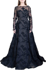 A woman wearing a Jason Wu Collection Embroidered Organza Gown, featuring lace appliqués and floral patterns, stands against a plain white background.