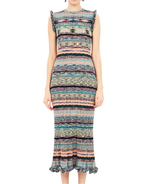 A woman wears the Ulla Johnson Ajak Knit Dress, a ribbed, sleeveless midi crafted from space-dyed yarn with horizontal multicolored stripes and ruffled shoulder and hem edges.