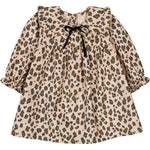The Louis Louise Baby Girls' Benjamina Corduroy Leopard Dress features long sleeves, an all-over leopard print on beige, a ruffled Peter Pan collar, and a small black bow at the neckline.