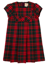 The Girls' Darcy Dress by The Beaufort Bonnet Company showcases a red, green, and navy Paces Mill Plaid, short sleeves, a front bow, and a pleated skirt, set against a white background.