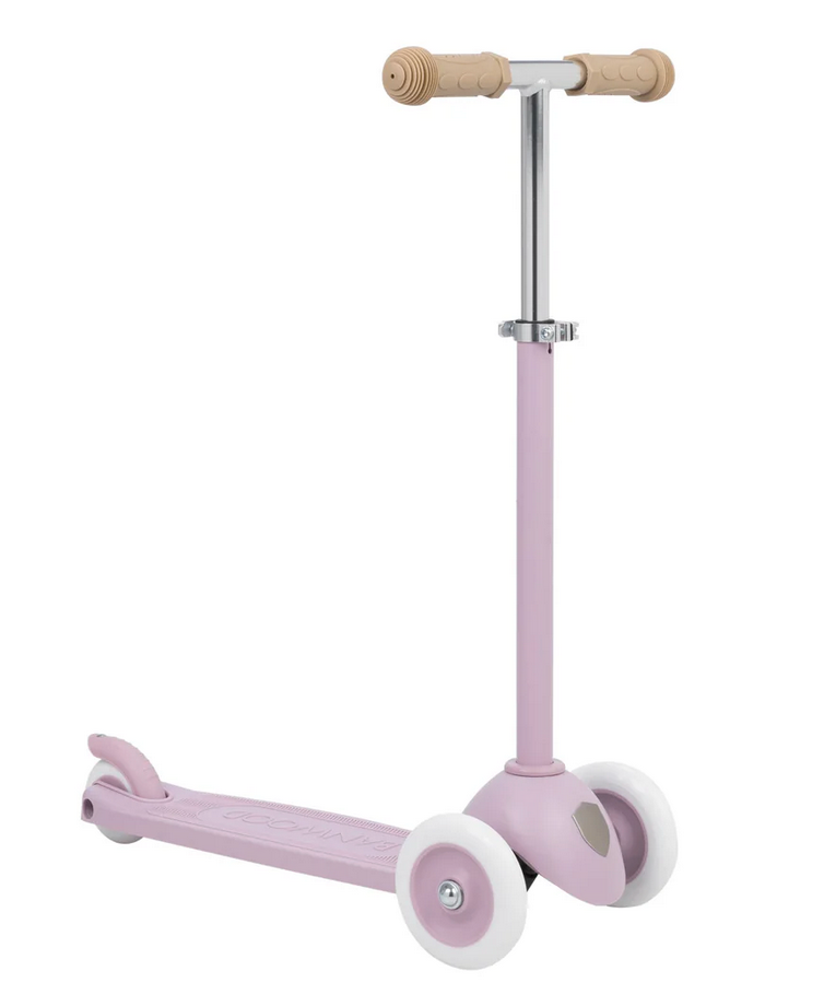 The Banwood Eco Scooter, part of the Eco Collection, features three wheels, a pink body, beige handlebars, and white wheels. It's made partly from recycled plastic and is shown on a white background.