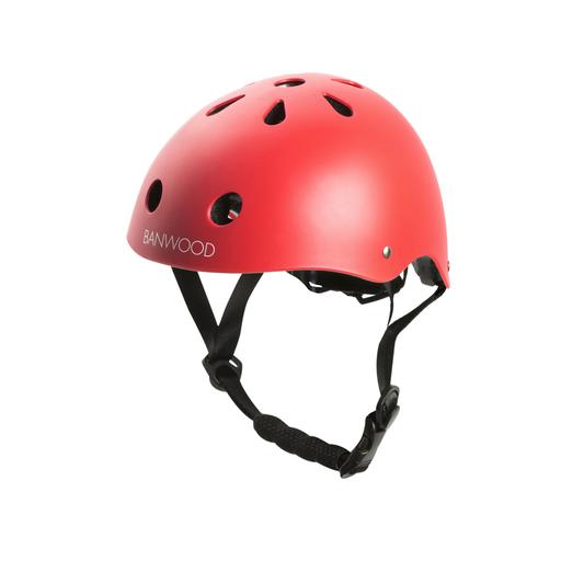 The Banwood Children’s Helmet is shown against a white background. It features a red design with multiple ventilation holes, protective inner foam, and an adjustable black chin strap.