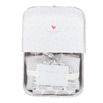 The Pink Chicken Nesting Box Baby Take Home Set features folded striped and animal-print organic pima cotton baby clothing, presented in a gift box with ribbon and card—perfect for newborns.