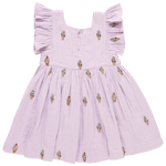 The Girls' Elsie Dress by Pink Chicken is a lilac delight made from 100% cotton double cloth gauze, featuring ruffled sleeves and a fun Lavender Soft Serve ice cream cone pattern.