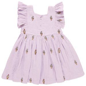 The Girls' Elsie Dress by Pink Chicken is a lilac delight made from 100% cotton double cloth gauze, featuring ruffled sleeves and a fun Lavender Soft Serve ice cream cone pattern.