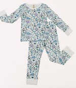 The Timo & Violet Kids' The Two Piece Pajamas feature long sleeves and pants in a white floral print with blue, green, and purple accents. Made from organic cotton, this set offers both comfort and style for a cozy night’s sleep.