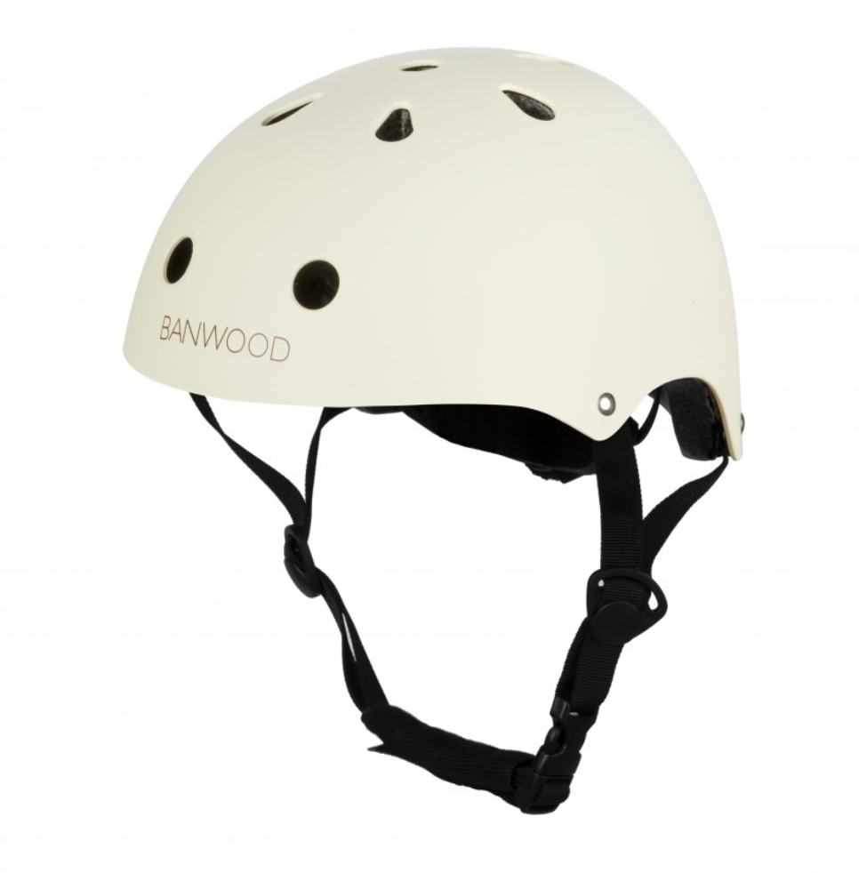The Banwood Children’s Helmet is cream-colored, features an ABS hard shell, ventilation holes, an adjustable chin strap, and a secure buckle.
