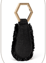 The Fray Raffia Hat Clip by Toptote is a black textured keychain featuring frayed edges and a hexagonal gold ring, perfect for hands-free travel.