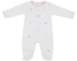 The Beaufort Bonnet Company Baby Girls' Rock Me Romper: white onesie with long sleeves, pink trim, and scattered pink and purple bow patterns, shown on a plain background.