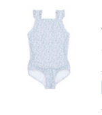 The Minnow Baby Girls' and Girls' Ruffle Sleeve Rashguard One Piece features a light blue floral pattern, ruffle shoulder straps, and a grosgrain ribbon bow, shown laid flat on a white background.