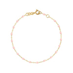 The Classic Gigi Bracelet 6.7" by Gigi Clozeau showcases an elegant design with a delicate thin 18 carat yellow gold chain, small pink beads, and a secure clasp closure, embodying timeless style.