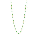 The Gigi Clozeau Classic Gigi Necklace, 16.5", is a stunning accessory that showcases a yellow gold chain adorned with striking jewels and evenly spaced green oval beads.
