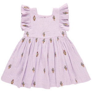 The Pink Chicken Girls' Elsie Dress features a lavender soft serve design, crafted from 100% cotton double cloth gauze with a charming ice cream cone pattern and delicate ruffled sleeves.