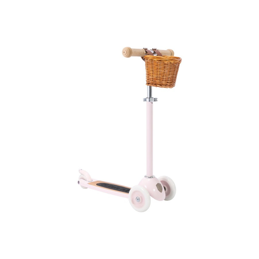 The Banwood Scooter is a pink three-wheel scooter with a wicker basket on the handlebars, designed to support child development and shown on a white background.