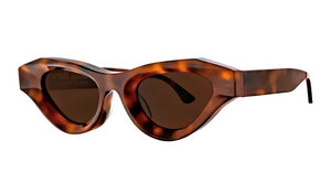 The Thierry Lasry Jaya sunglasses showcase a chic geometric style with dark lenses and thick tortoiseshell cat-eye frames.