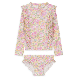 The Louise Misha Yanika Bathing Set by Louise Misha is a two-piece children’s swimsuit with a floral pastel print, featuring a long-sleeve rash guard top with ruffles and matching bikini bottoms.