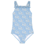 The Minnow Girls' Capel Ruched Strap One Piece is a fully lined light blue swimsuit adorned with a charming white floral pattern and delicate ruffled shoulder straps, crafted from exquisite Liberty Fabric.