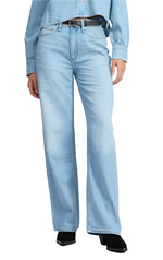 Someone confidently wears Rag & Bone Featherweight Logan Mid-Rise Wide Leg denim jeans in light blue, paired with a matching denim shirt, a sleek black belt, and polished black shoes, all against a crisp white background.