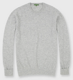 The Sid Mashburn Classic Crewneck Cashmere Sweater in light grey is shown laid flat, showcasing its ribbed cuffs, hem, and neckline.