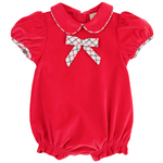 The Beaufort Bonnet Company’s Baby Girls' Banks Bow Bubble is a red velveteen romper with short puff sleeves, a Peter Pan collar, and a plaid bow, with matching plaid trim on the cuffs and collar.