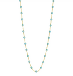 The Classic Gigi Necklace 16.5" by Gigi Clozeau features 18 carat yellow gold and evenly spaced turquoise beads, creating an exquisite piece for any occasion.