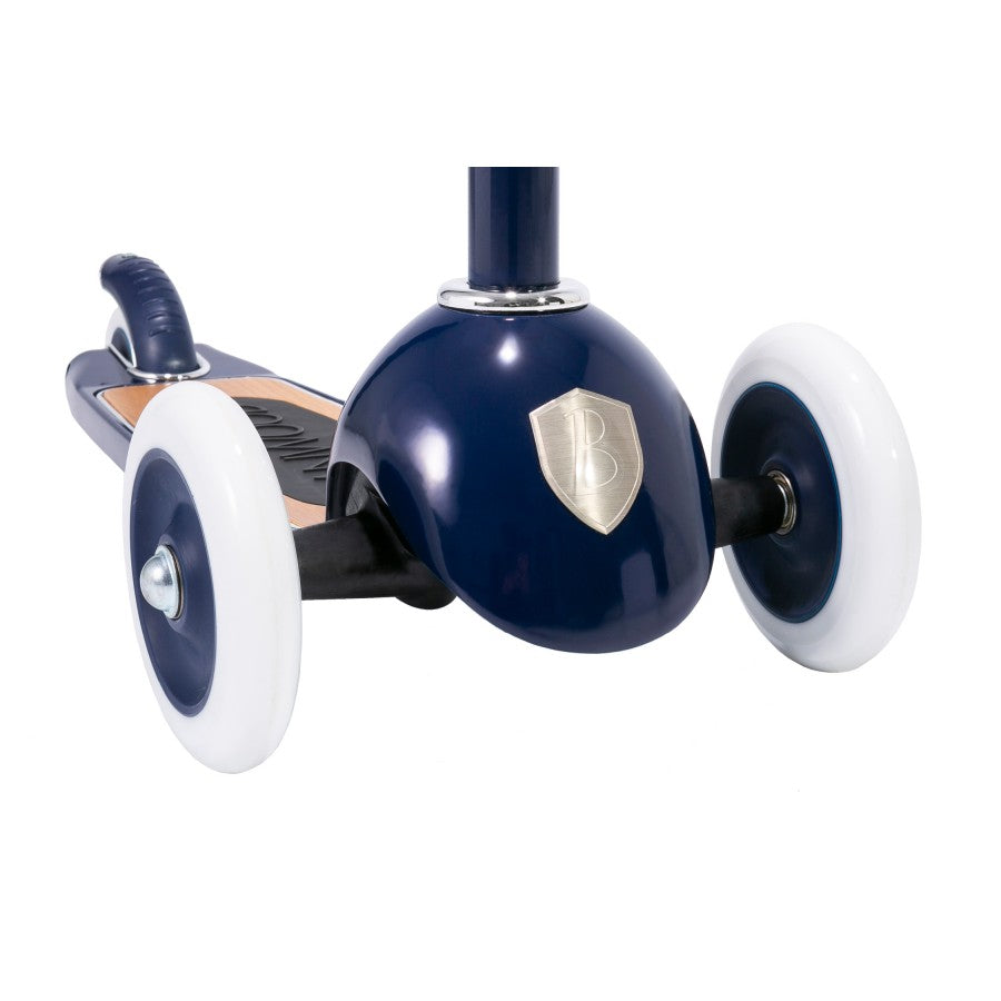 Banwood's blue and white three-wheeled toy scooter, featuring a bronze emblem, can be viewed from the front and is perfect for developing fine motor skills and balance.