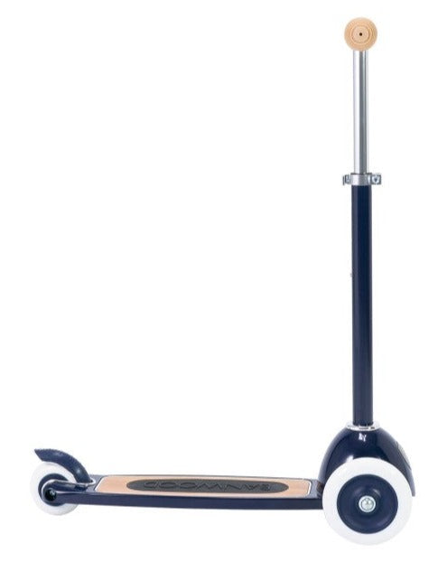 The Banwood Scooter, featuring a black and white design with two wheels, a wooden foot deck, and an upright handlebar, helps improve balance and fine motor skills.