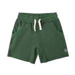 The Rylee & Cru Boys' Ventura Short features a green elastic waistband with white drawstring, raw edge details, two side pockets, and a small white logo on the left leg.