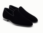 The Magnanni Jareth Slipper, a pair of black velvet loafers with an elegant silhouette and low heel, is perfect for formal occasions and displayed against a white background.